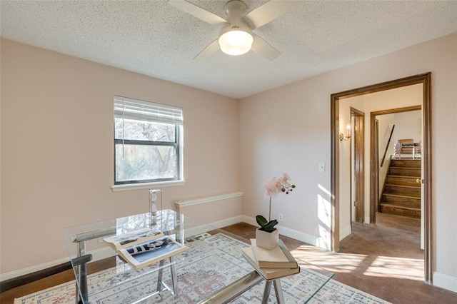 office with ceiling fan, carpet floors, and a textured ceiling