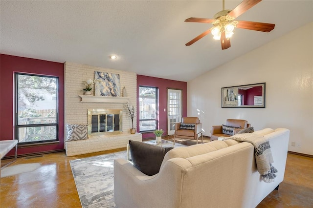 living room featuring vaulted ceiling, ceiling fan, and a fireplace