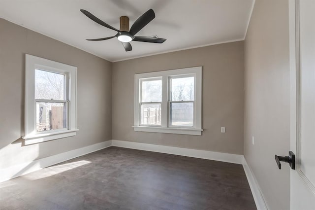 unfurnished room with a wealth of natural light, crown molding, and ceiling fan