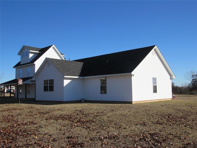 view of side of home with a lawn