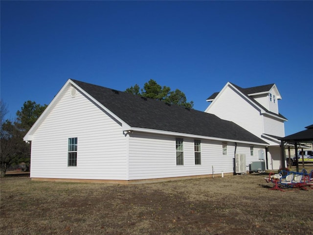 rear view of property with a lawn