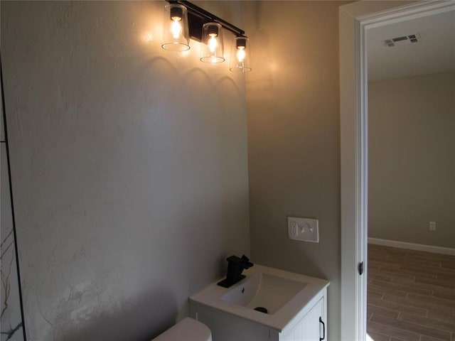 bathroom with wood-type flooring and sink