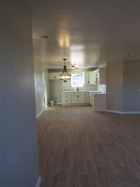 unfurnished living room featuring wood-type flooring