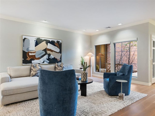 living room featuring wood-type flooring and ornamental molding