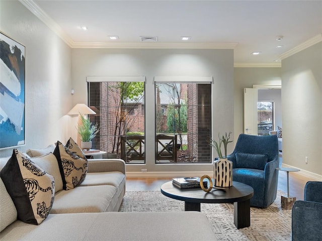 living room featuring light hardwood / wood-style floors and crown molding