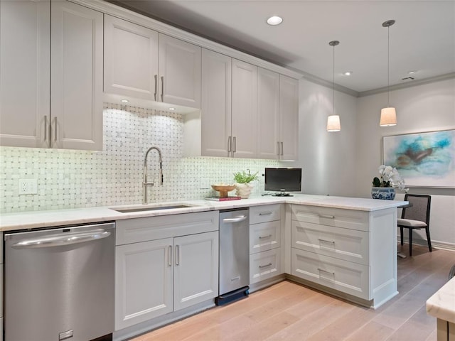 kitchen with dishwasher, sink, hanging light fixtures, kitchen peninsula, and decorative backsplash