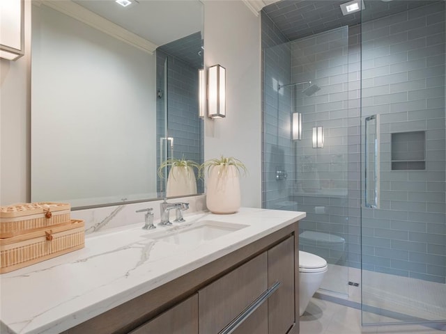 bathroom featuring vanity, tile patterned floors, toilet, ornamental molding, and an enclosed shower