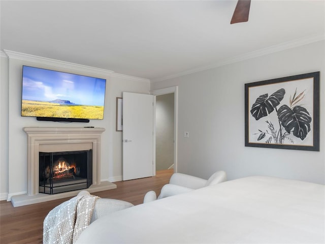 bedroom with ceiling fan, hardwood / wood-style floors, and ornamental molding