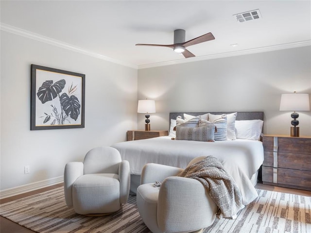 bedroom featuring ceiling fan, crown molding, and wood-type flooring