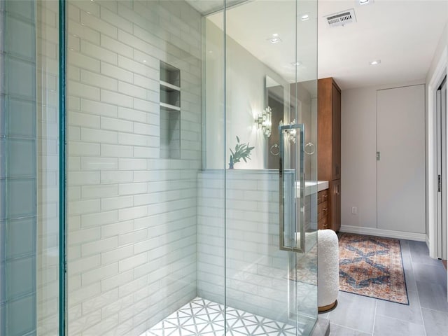 bathroom featuring tile patterned floors and an enclosed shower