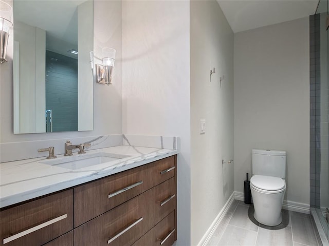 bathroom featuring tile patterned flooring, vanity, and toilet