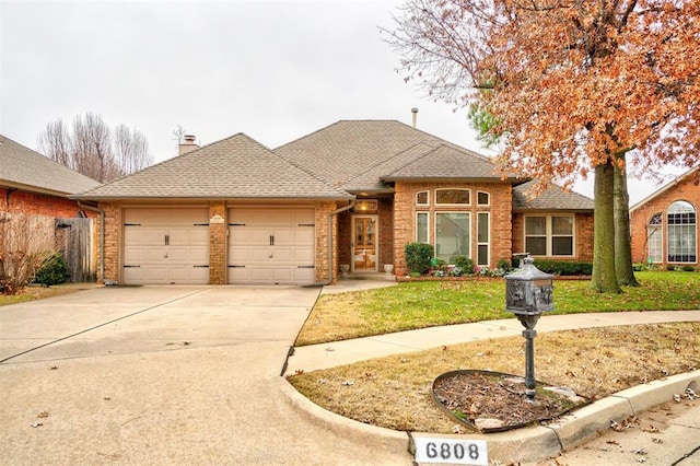 view of front of home with a front lawn and a garage