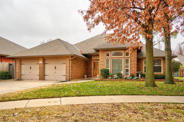 view of front of house with a garage and a front lawn