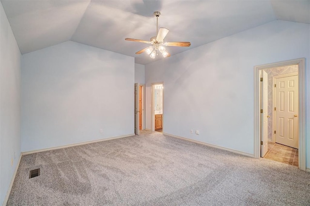 empty room with light carpet, vaulted ceiling, and ceiling fan