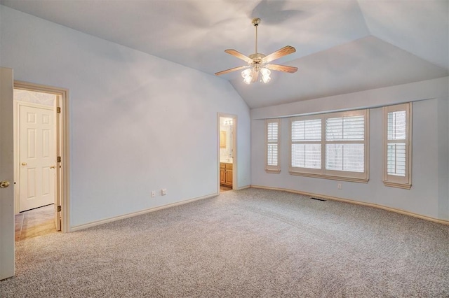 carpeted empty room featuring ceiling fan and lofted ceiling