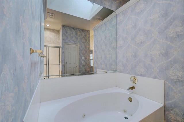 bathroom featuring a bathtub and a skylight