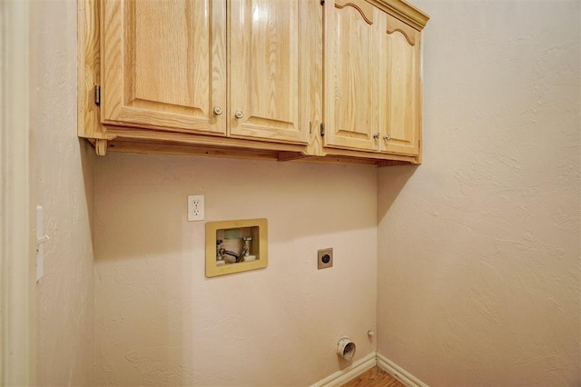 clothes washing area with hookup for an electric dryer, cabinets, and hookup for a washing machine