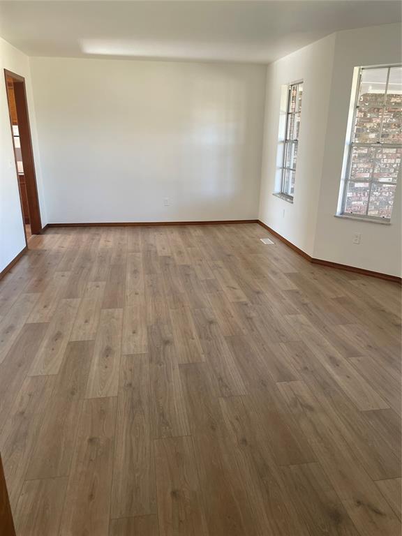 unfurnished room featuring light wood-type flooring