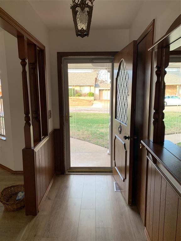 doorway to outside with light wood-type flooring