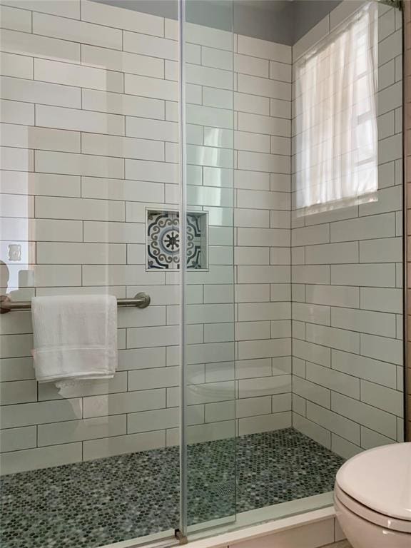 bathroom with walk in shower and toilet