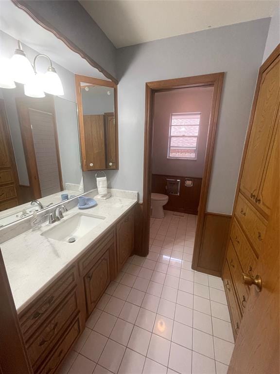 bathroom featuring toilet, vanity, and tile patterned floors