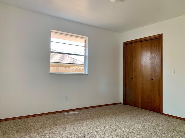 unfurnished bedroom with carpet flooring and a closet