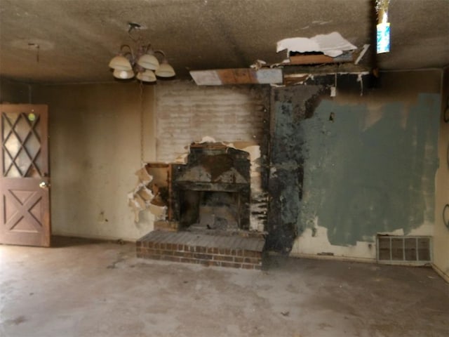 misc room featuring concrete flooring and a brick fireplace