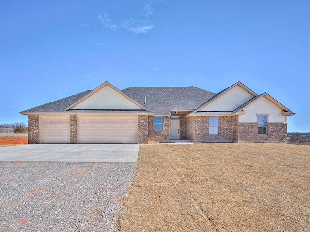 ranch-style house featuring brick siding, roof with shingles, a garage, driveway, and a front lawn