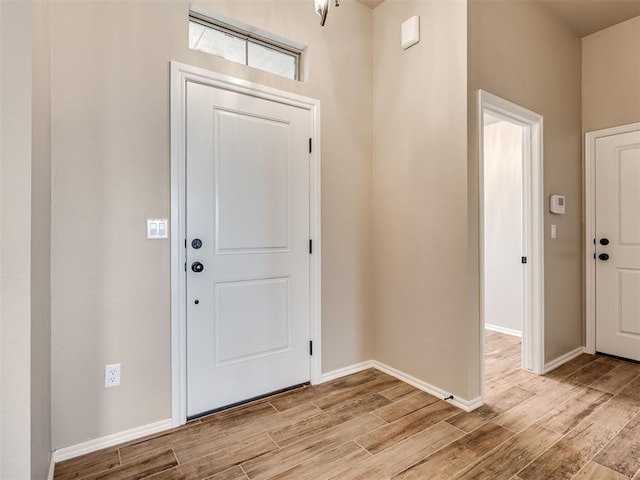 entryway featuring light wood-type flooring and baseboards