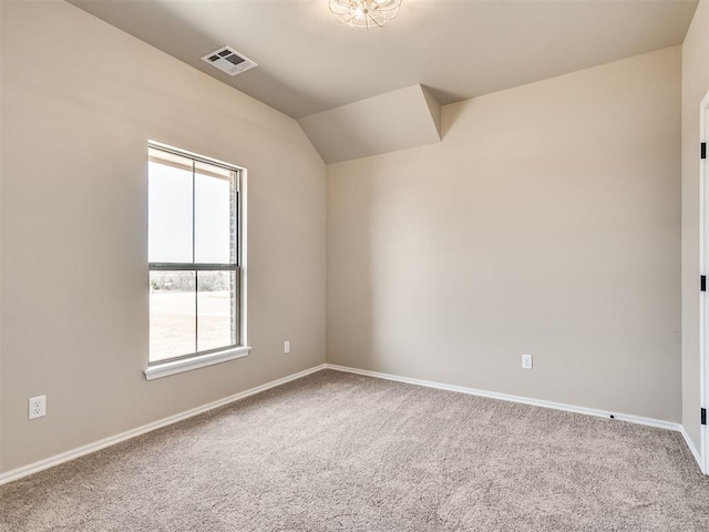 unfurnished room with carpet floors, baseboards, visible vents, and vaulted ceiling