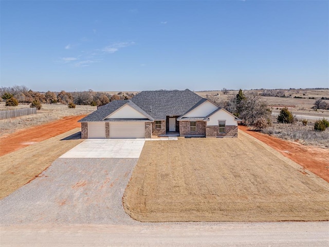 view of front facade with a garage, concrete driveway, and stone siding