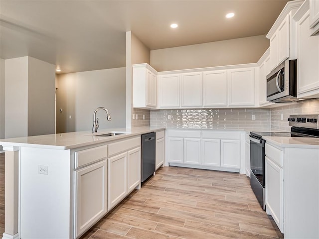 1995 Classic Run, Blanchard, OK 73010 - kitchen featuring appliances with stainless steel finishes, a sink, a peninsula, recessed lighting, and backsplash