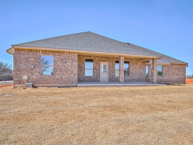 1995 Classic Run, Blanchard, OK 73010 - rear view of property featuring roof with shingles, brick siding, and a patio area