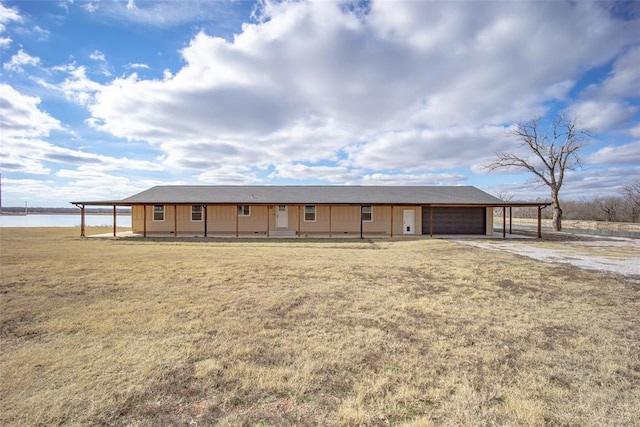 view of front facade with a water view and a carport