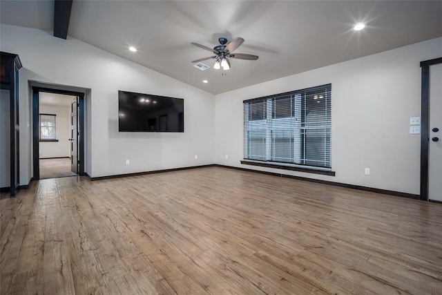 unfurnished living room with lofted ceiling with beams, light hardwood / wood-style flooring, and ceiling fan