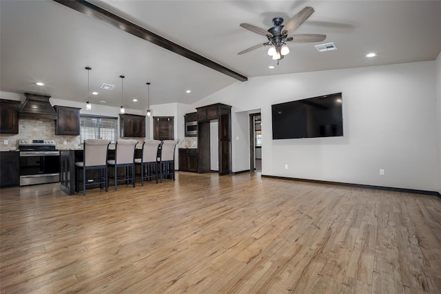 unfurnished living room with vaulted ceiling with beams, ceiling fan, and light hardwood / wood-style flooring