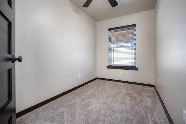 carpeted empty room featuring ceiling fan