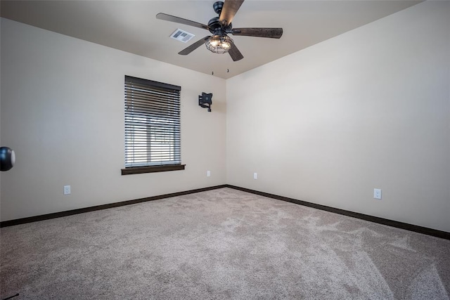 carpeted spare room with ceiling fan