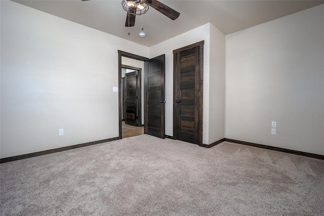 unfurnished bedroom with ceiling fan and light carpet