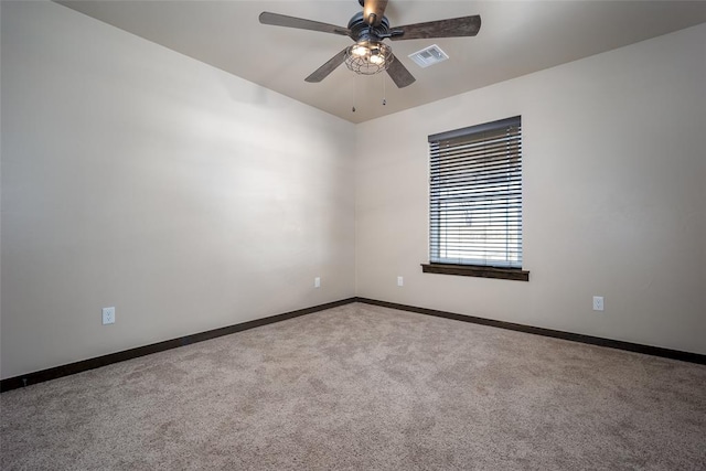 spare room featuring light carpet and ceiling fan