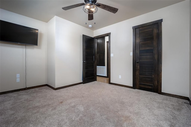 unfurnished bedroom featuring ceiling fan and light colored carpet