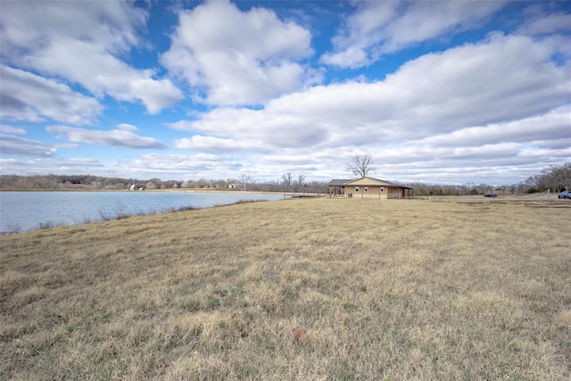 view of yard with a rural view and a water view