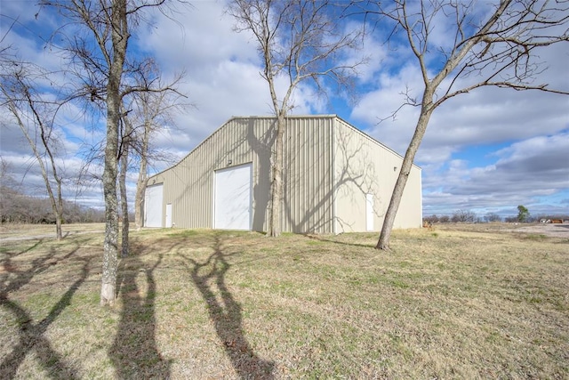 view of outbuilding with a garage and a yard