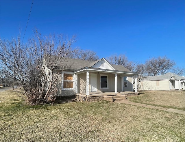 view of front of home with covered porch and a front yard