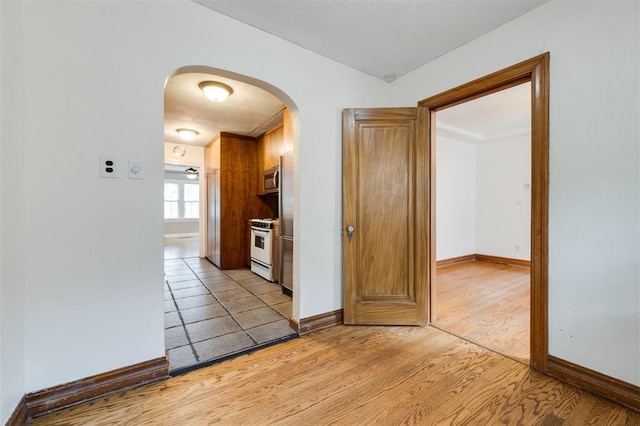 hallway with light hardwood / wood-style flooring