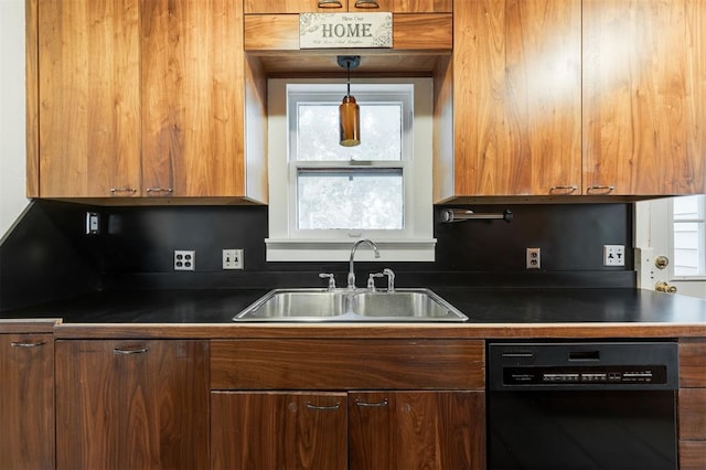 kitchen featuring sink, black dishwasher, and hanging light fixtures