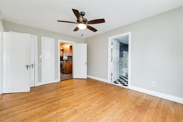 unfurnished bedroom featuring ceiling fan, light hardwood / wood-style floors, and ensuite bath