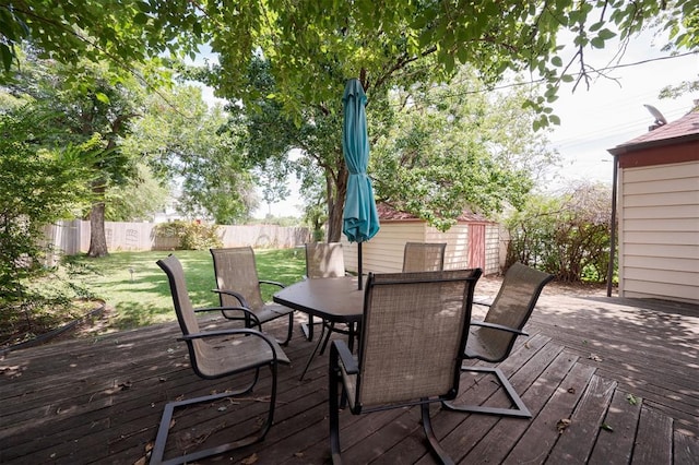 wooden terrace featuring a lawn