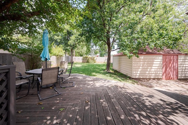 deck featuring a storage shed and a lawn