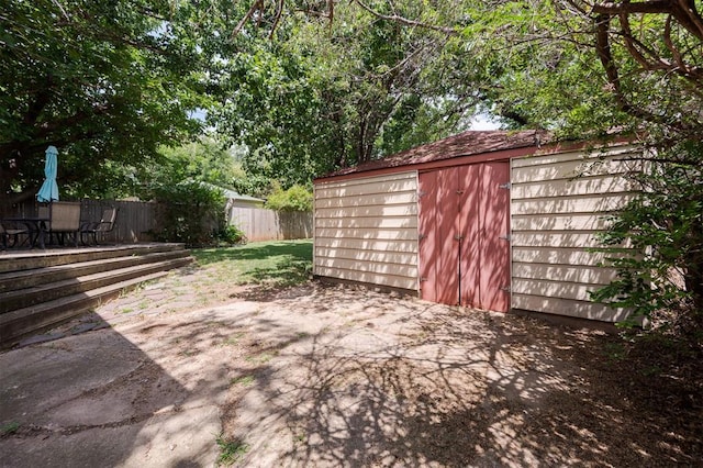 view of yard with a shed and a patio